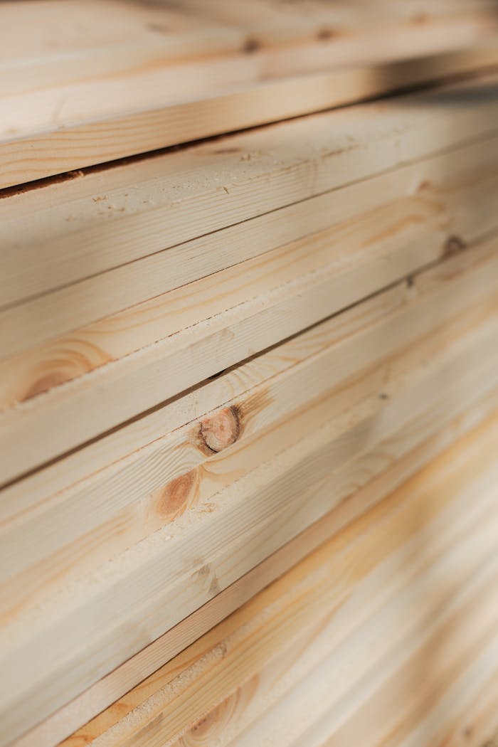 Crafting Captivating Headlines: Your awesome post title goes here Close-up view of neatly stacked wooden planks highlighting their natural texture and grain.